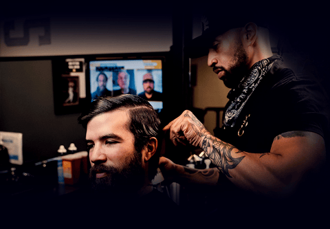 Man getting hair cute at Hammer & Nails