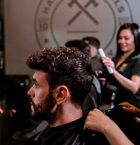Man receiving haircut at Hammer & Nails