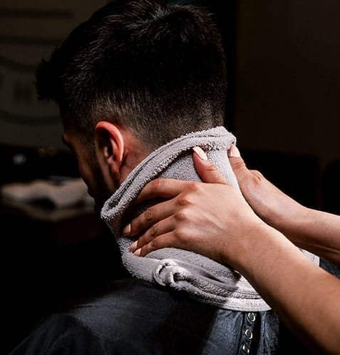 hot towel being applied to back of neck