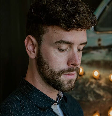 man with beard looking down