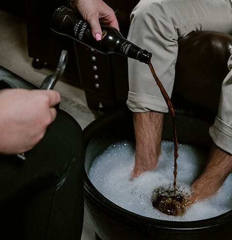 Pouring beer into foot soak at Hammer & Nails