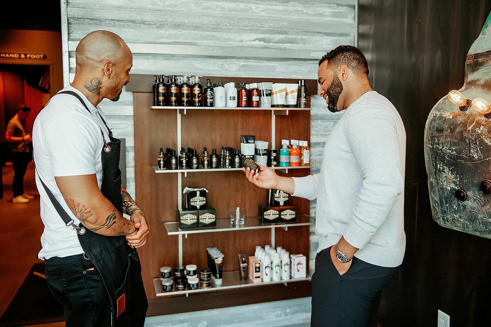 Two men standing seeing the beard oil and cream